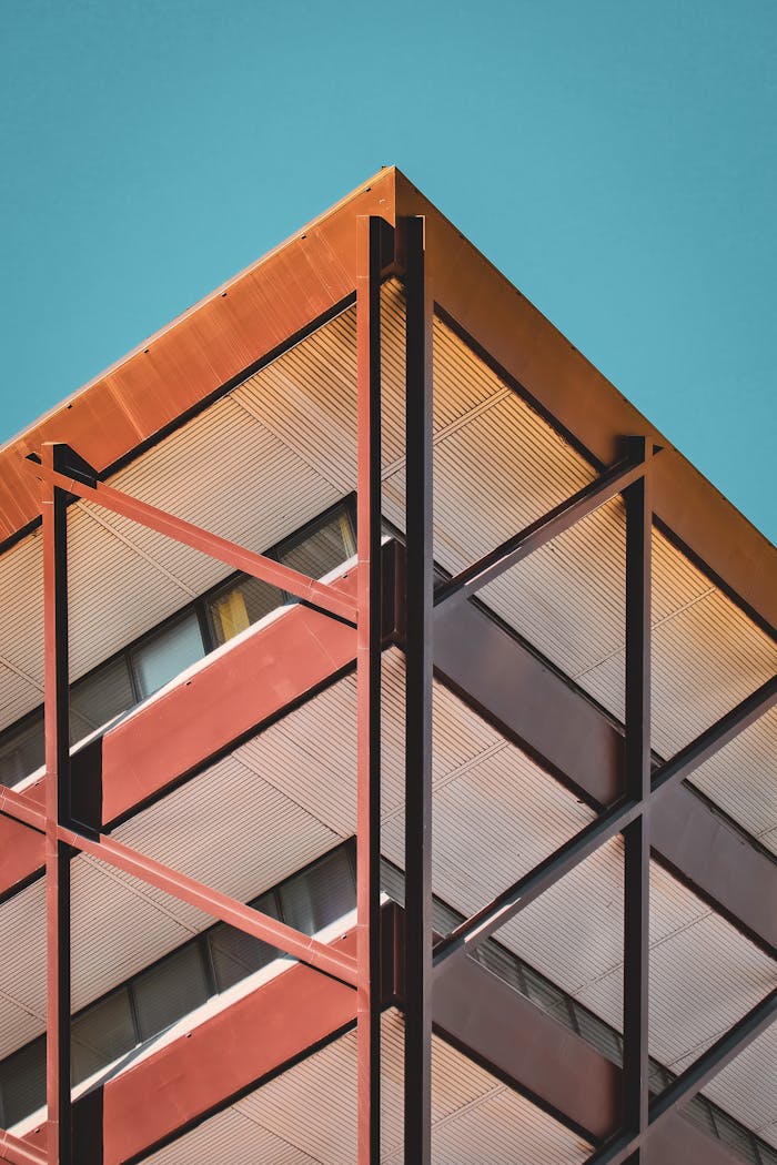 Close-up of a modern building corner against a clear sky, highlighting urban architecture.