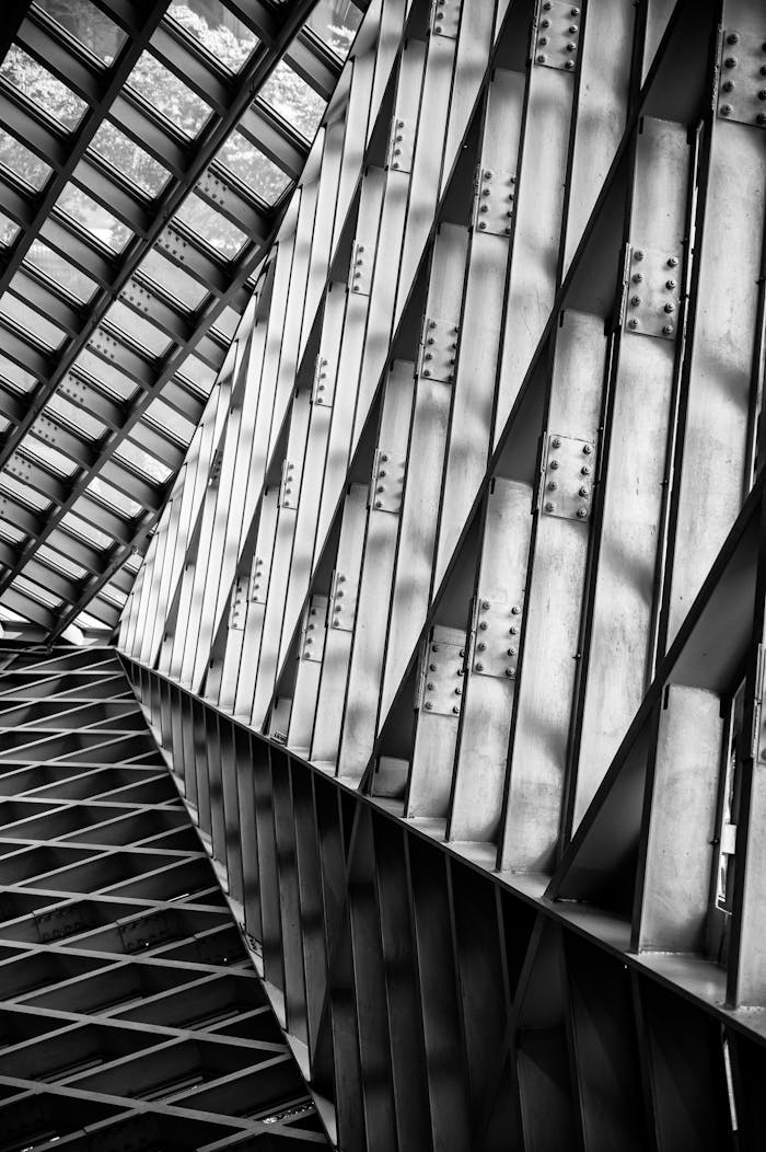 Black and white abstract view of industrial steel trusses in modern architecture.